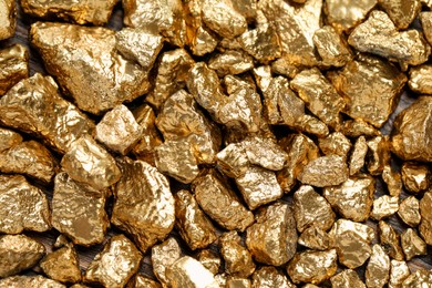 Photo of Pile of gold nuggets as background, top view