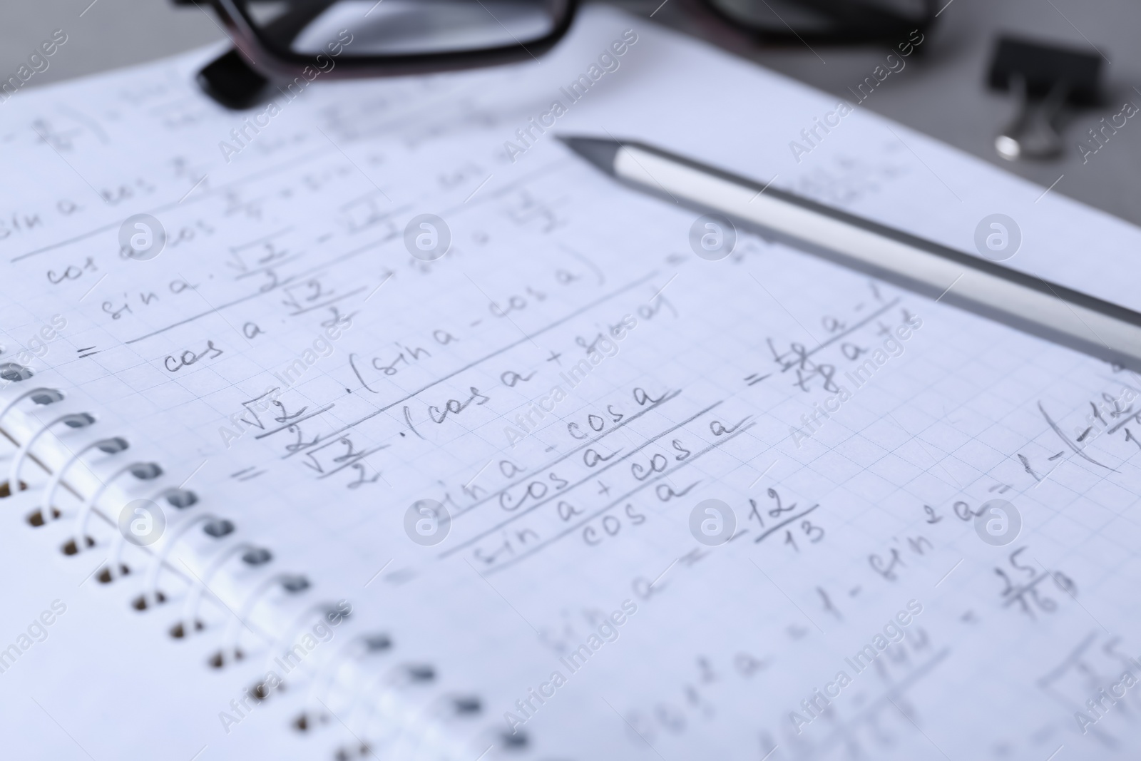 Photo of Notebook with pencil on table, closeup. Doing homework