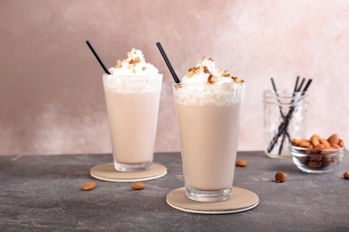 Photo of Glasses with delicious milk shakes on table