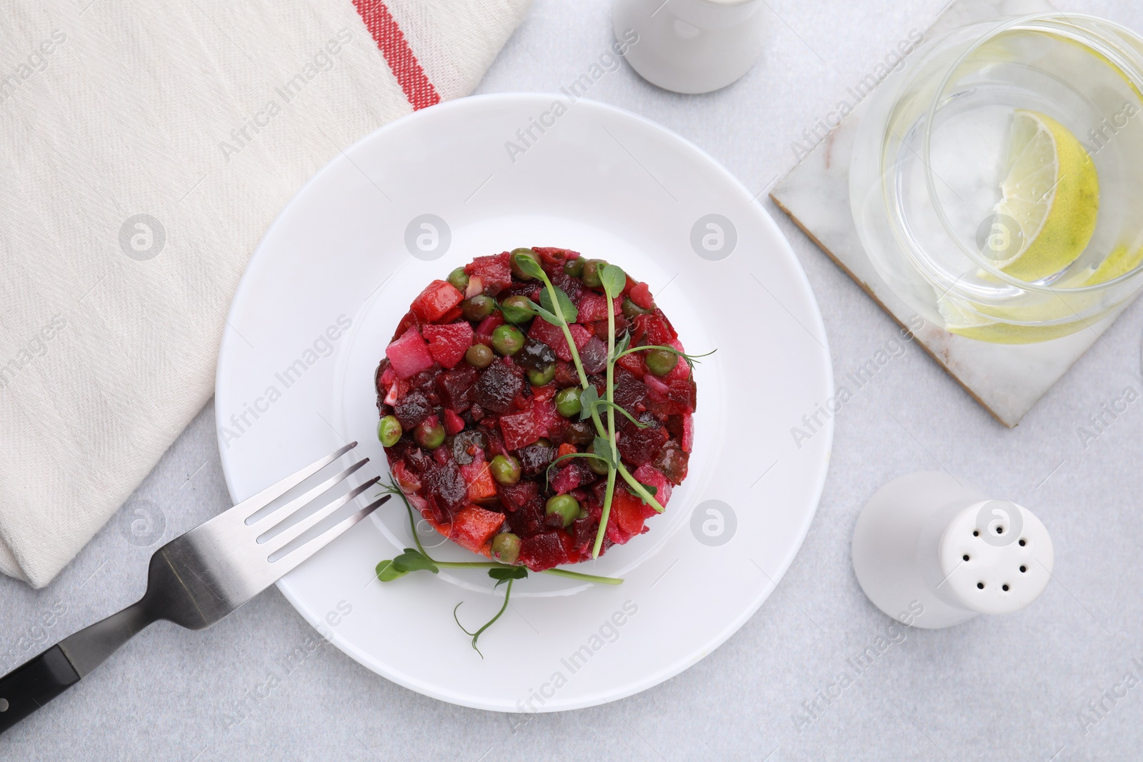 Photo of Delicious vinaigrette salad on light grey table, flat lay