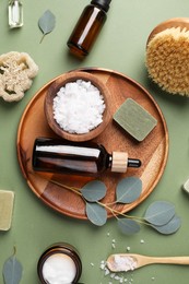 Photo of Flat lay composition with different spa products and eucalyptus branches on olive background