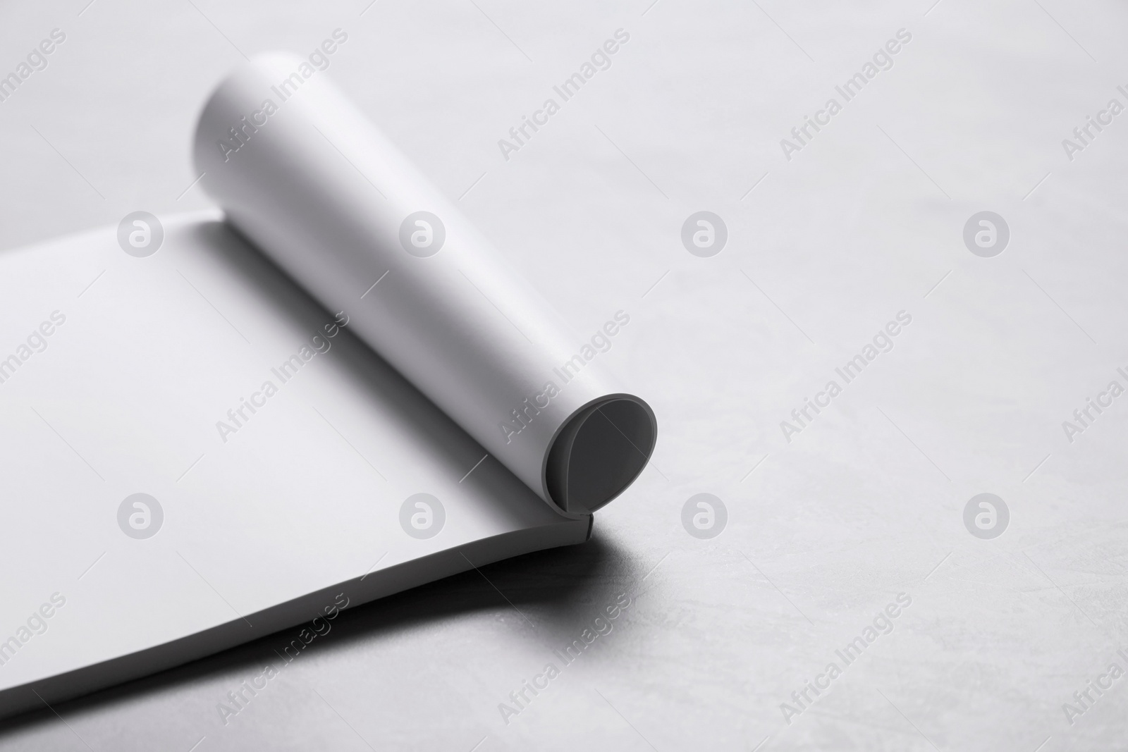 Photo of Blank paper sheets on grey textured table. Mockup for design