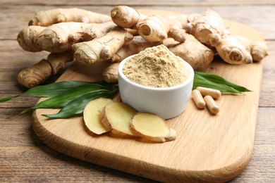 Photo of Dry, fresh and capsuled ginger on wooden table