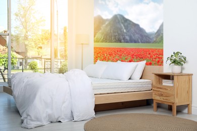 Sunlit bedroom. Interior with comfortable bed and mountain landscape wallpapers