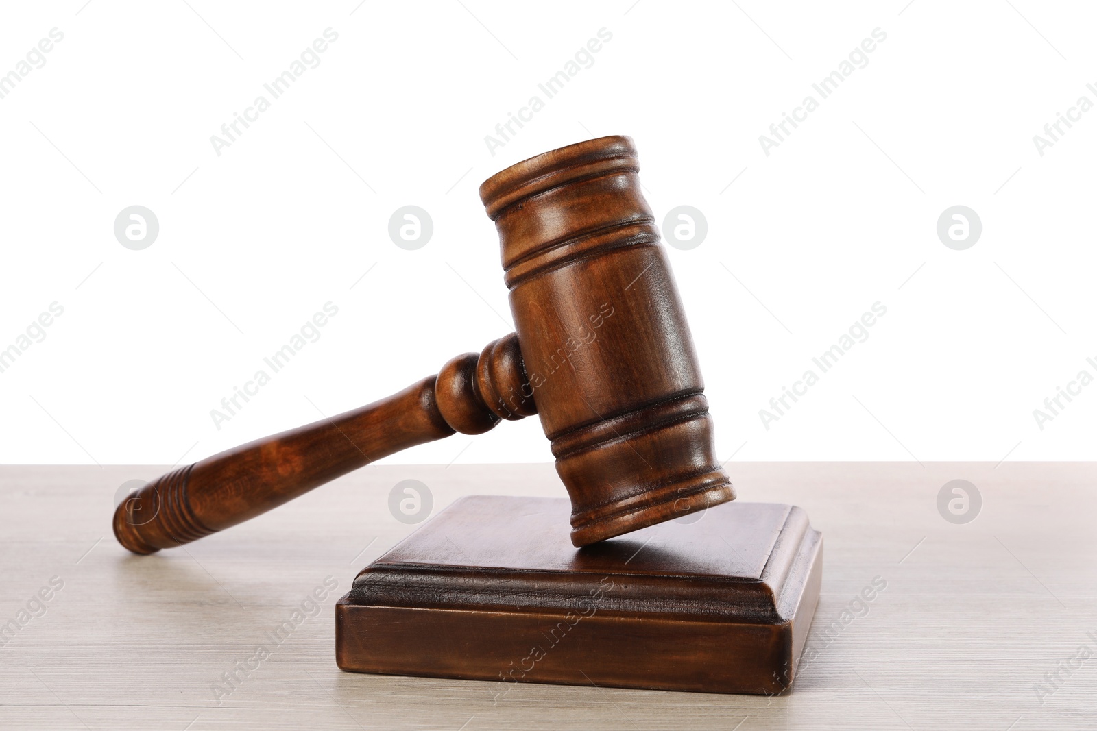 Photo of Wooden gavel on light table against white background