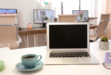 Stylish workplace with laptop on table