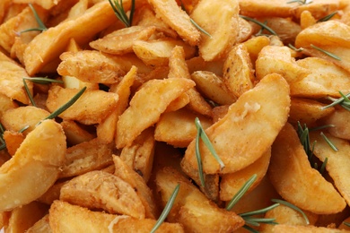 Photo of Baked potatoes with rosemary as background, closeup