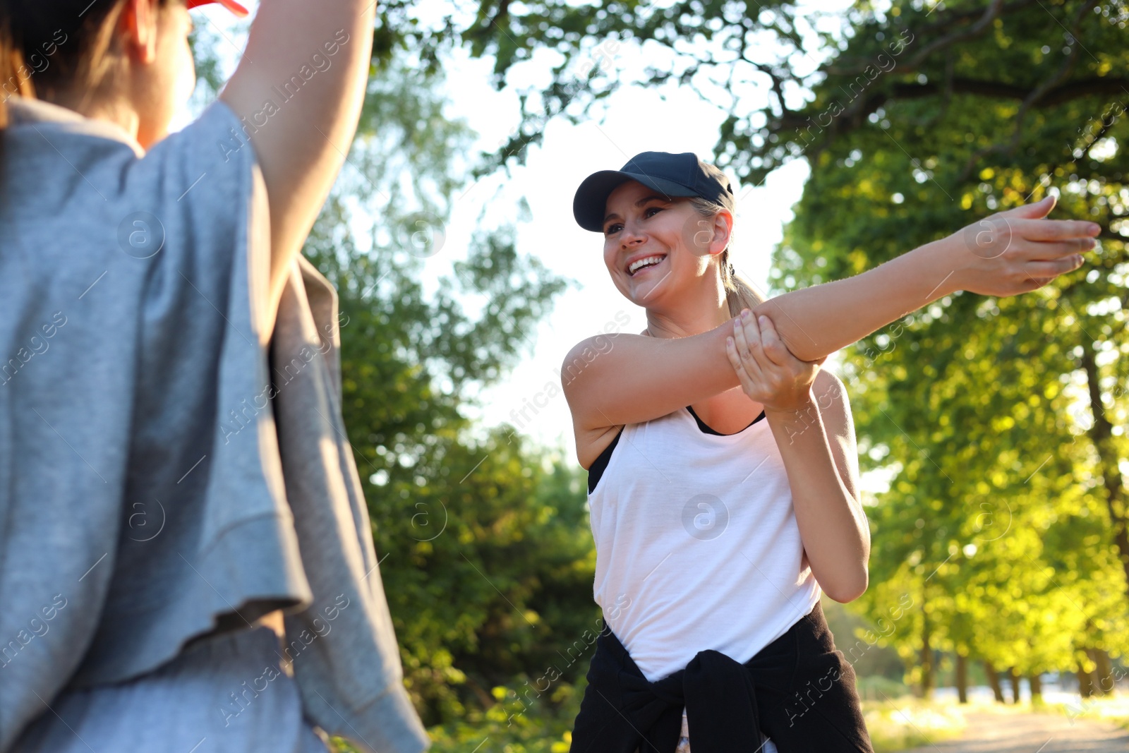 Photo of Women doing morning exercises in park on sunny day