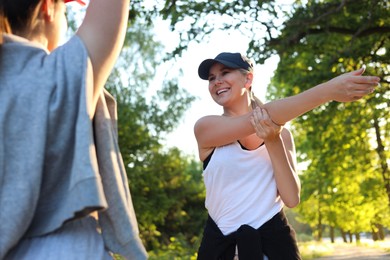 Photo of Women doing morning exercises in park on sunny day