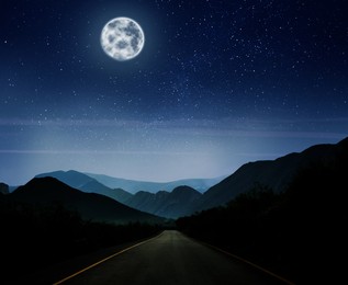 Image of Road leading to mountains under starry sky on full moon night