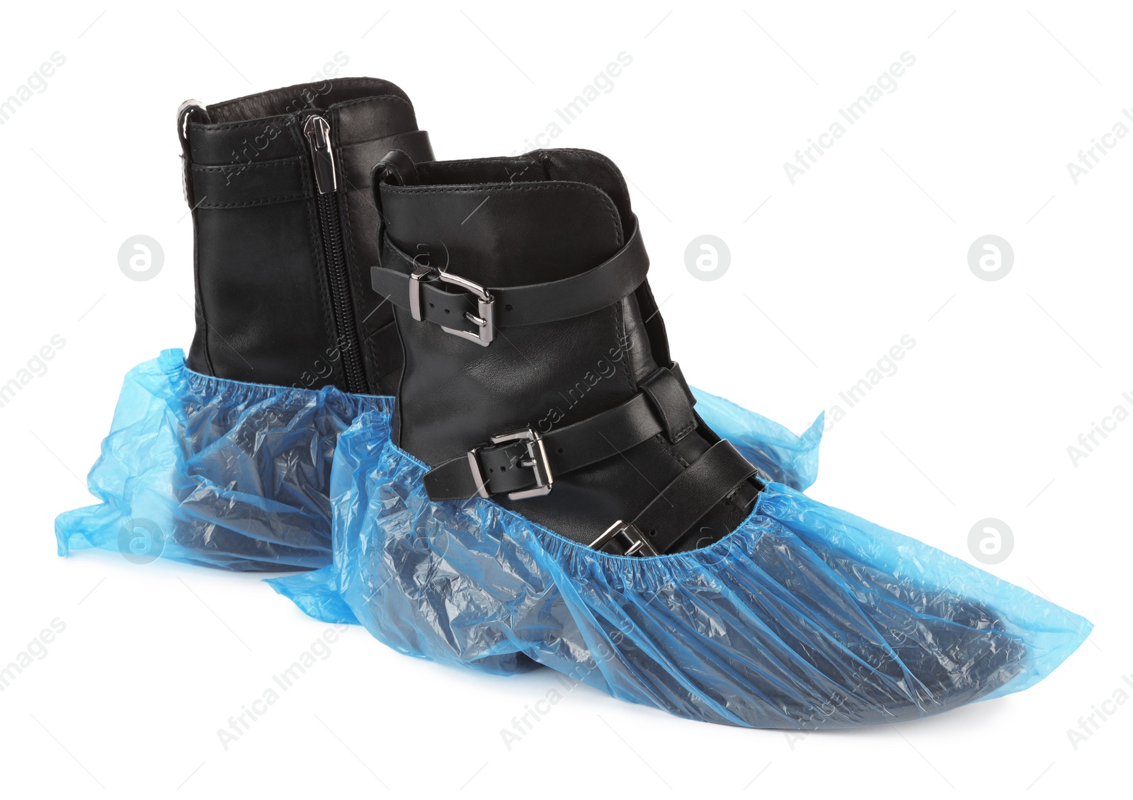 Photo of Women's boots in blue shoe covers isolated on white