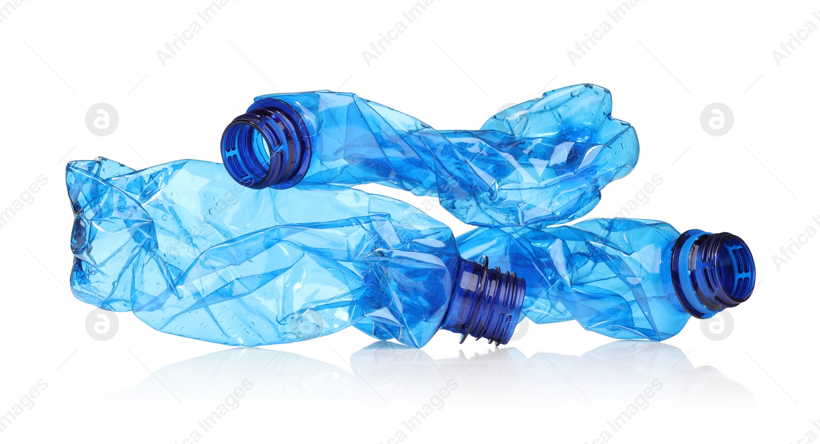 Photo of Crumpled disposable plastic bottles isolated on white