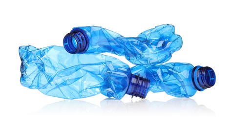 Photo of Crumpled disposable plastic bottles isolated on white