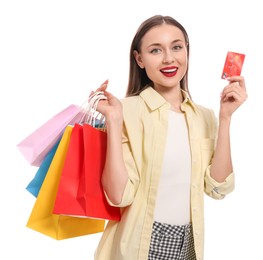 Stylish young woman with shopping bags and credit card white background