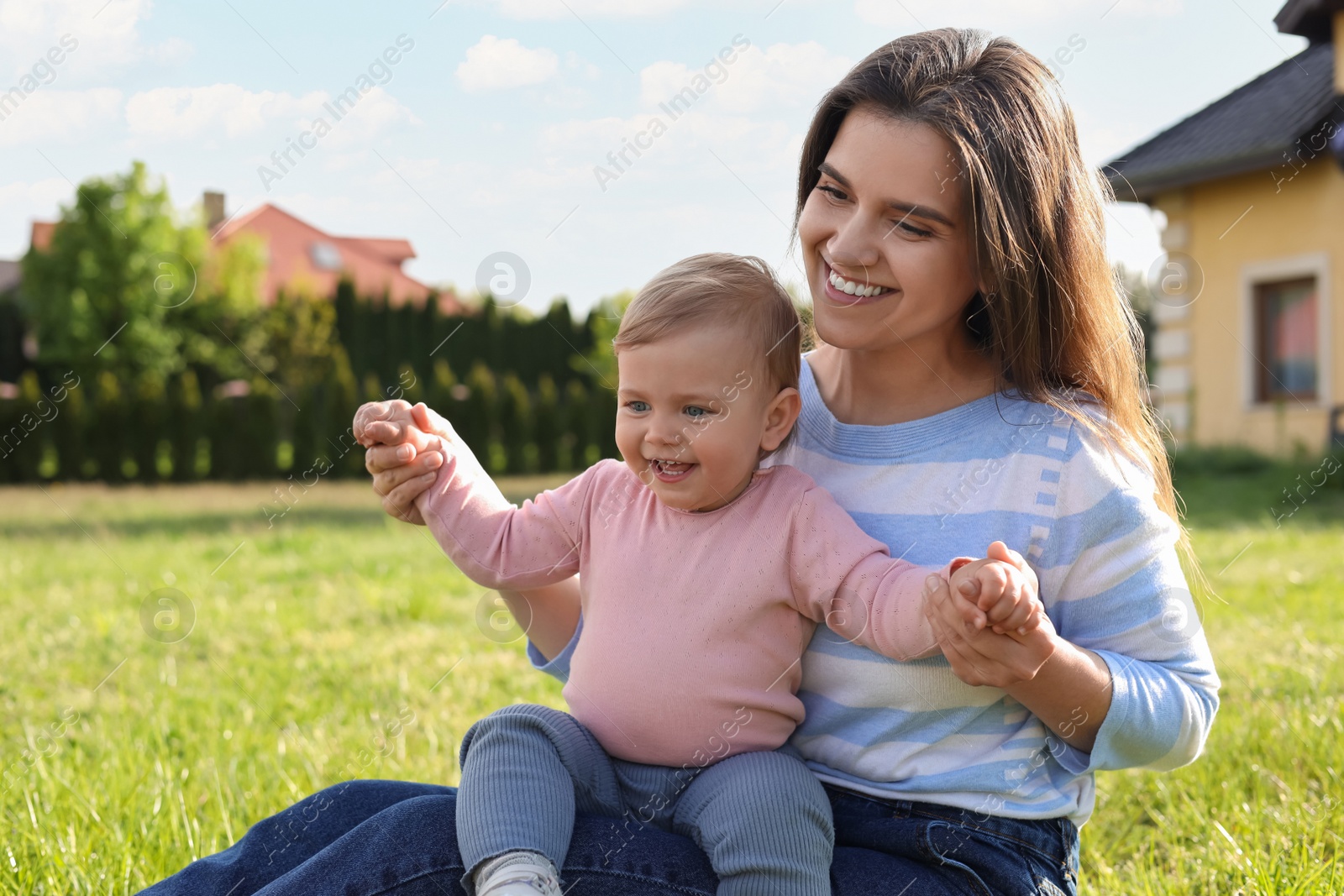 Photo of Happy mother with her cute baby at backyard on sunny day