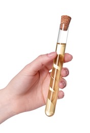 Photo of Woman holding test tube with light brown liquid on white background, closeup