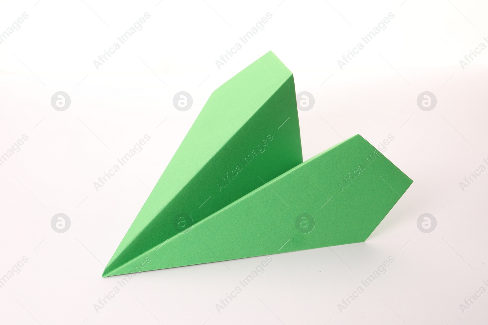 Photo of Handmade green paper plane isolated on white