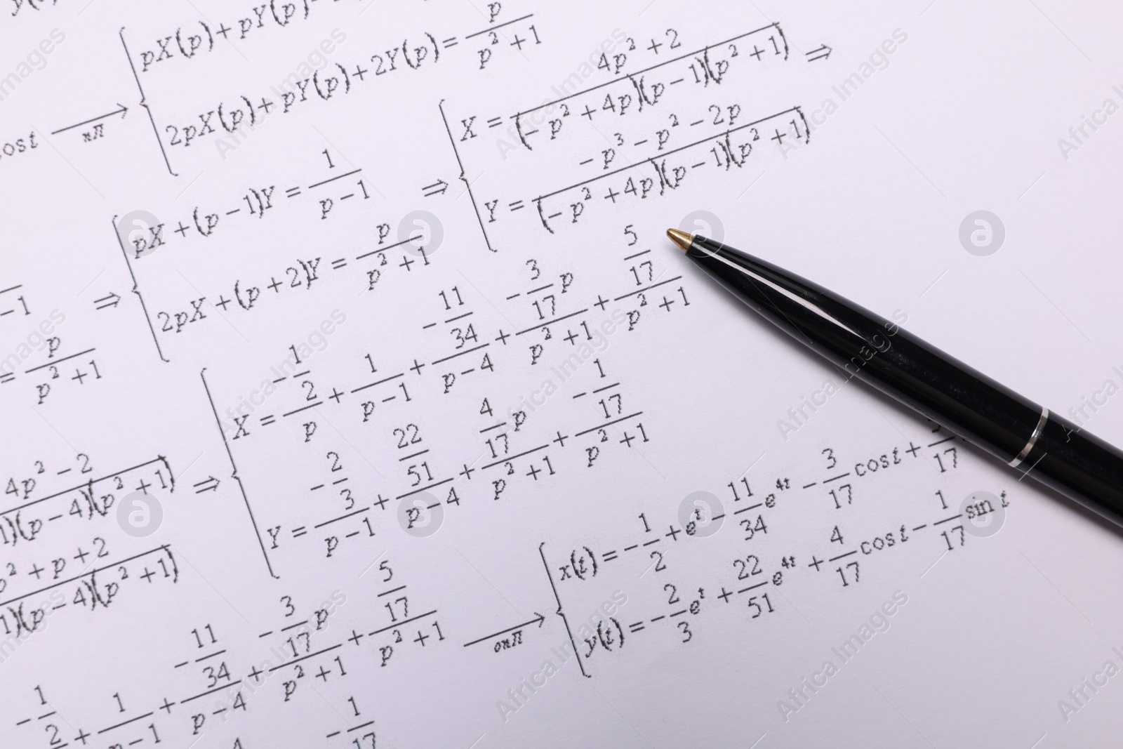 Photo of Sheet of paper with mathematical formulas and pen, top view