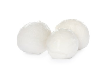 Delicious mozzarella cheese balls on white background