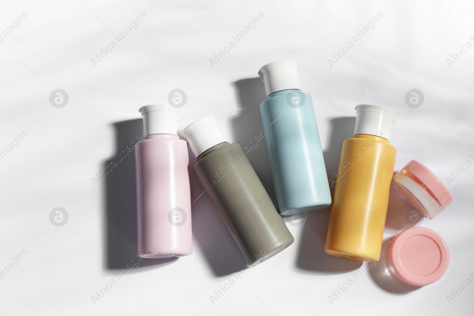 Photo of Cosmetic travel kit on white background, top view