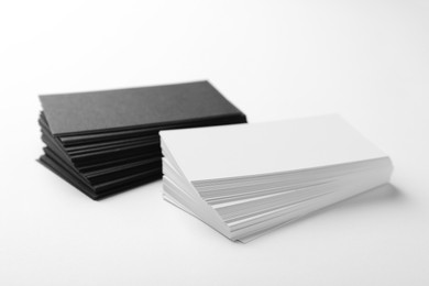 Photo of Many blank business cards on white background, closeup. Mockup for design