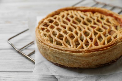 Freshly baked rhubarb pie on light wooden table, closeup