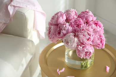 Photo of Bouquet of beautiful peonies on table indoors. Space for text