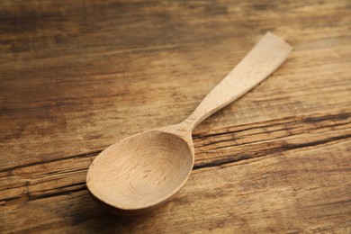 Photo of Handmade wooden spoon on rustic table, closeup