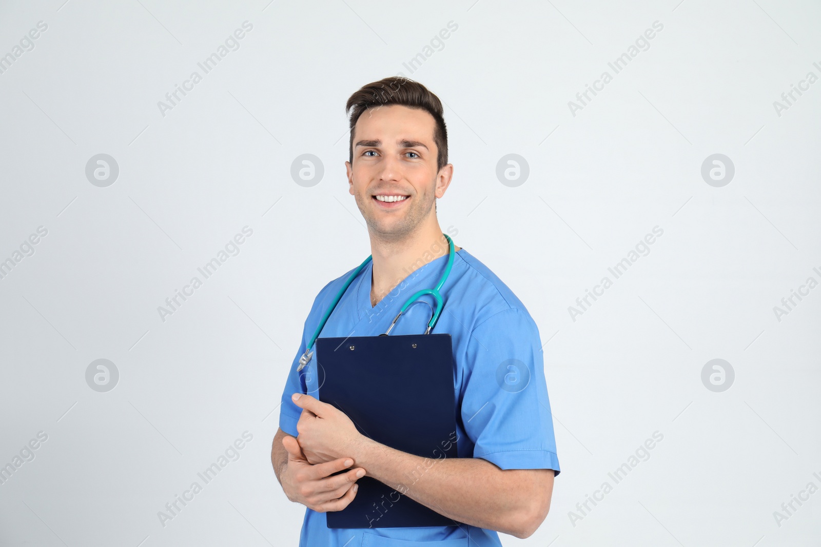 Photo of Portrait of medical assistant with stethoscope and clipboard on light background