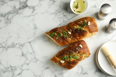 Photo of Flat lay composition with homemade garlic bread and space for text on table