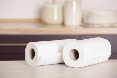 Photo of Rolls of paper towels on table in kitchen