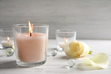 Photo of Beautiful composition with burning wax candle on table