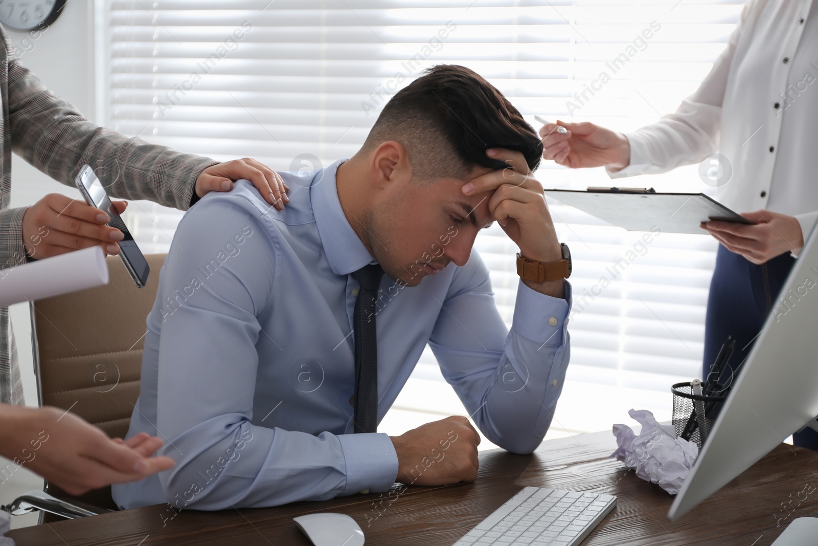 Photo of Businessman stressing out at workplace in office