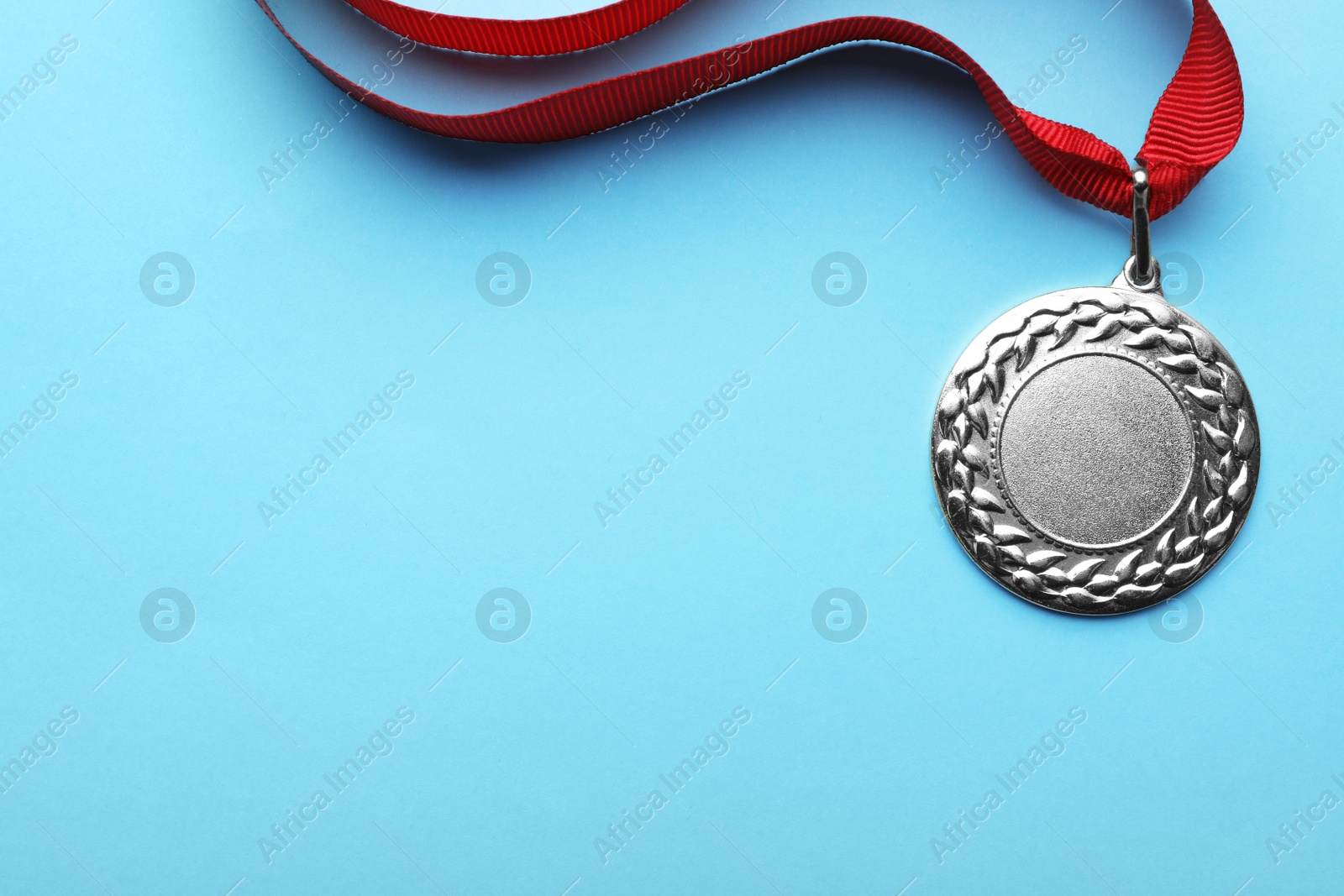 Photo of Gold medal with space for design on color background, top view. Victory concept