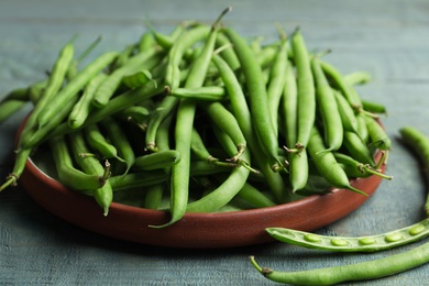 Fresh green beans on blue wooden table, closeup