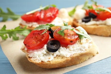 Photo of Delicious tomato bruschettas on table, closeup. Traditional Italian antipasto