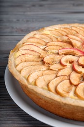 Photo of Freshly baked delicious apple pie on wooden table, closeup
