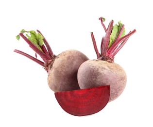 Photo of Whole and cut ripe beetroots on white background