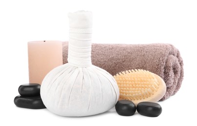 Herbal massage bag, spa stones, brush, towel and candle isolated on white