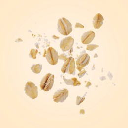 Image of Rolled oat flakes falling on beige background