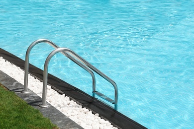 Modern swimming pool with stairs at resort