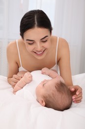 Young mother with her little baby at home