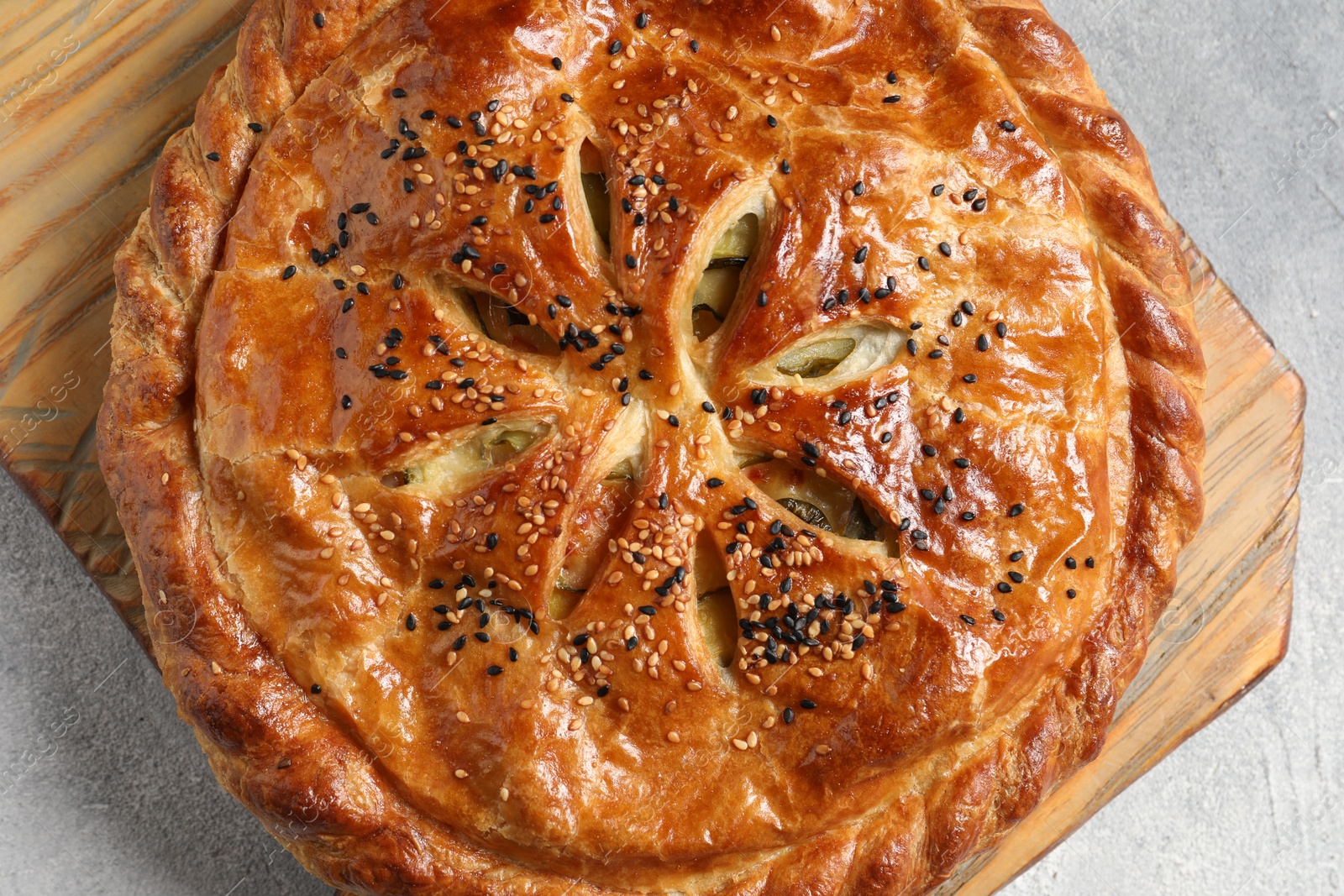 Photo of Tasty homemade pie with filling on light grey table, top view