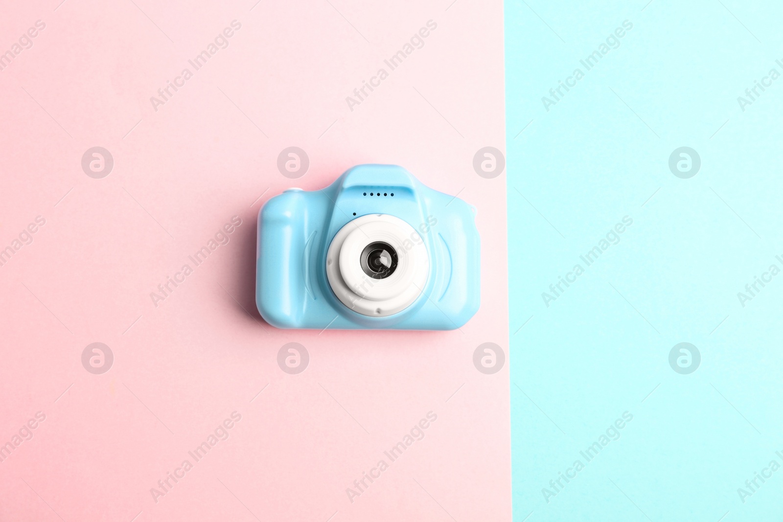 Photo of Light blue toy camera on color background, top view. Future photographer