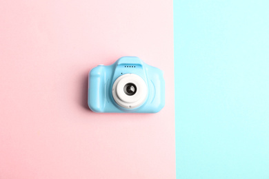 Photo of Light blue toy camera on color background, top view. Future photographer