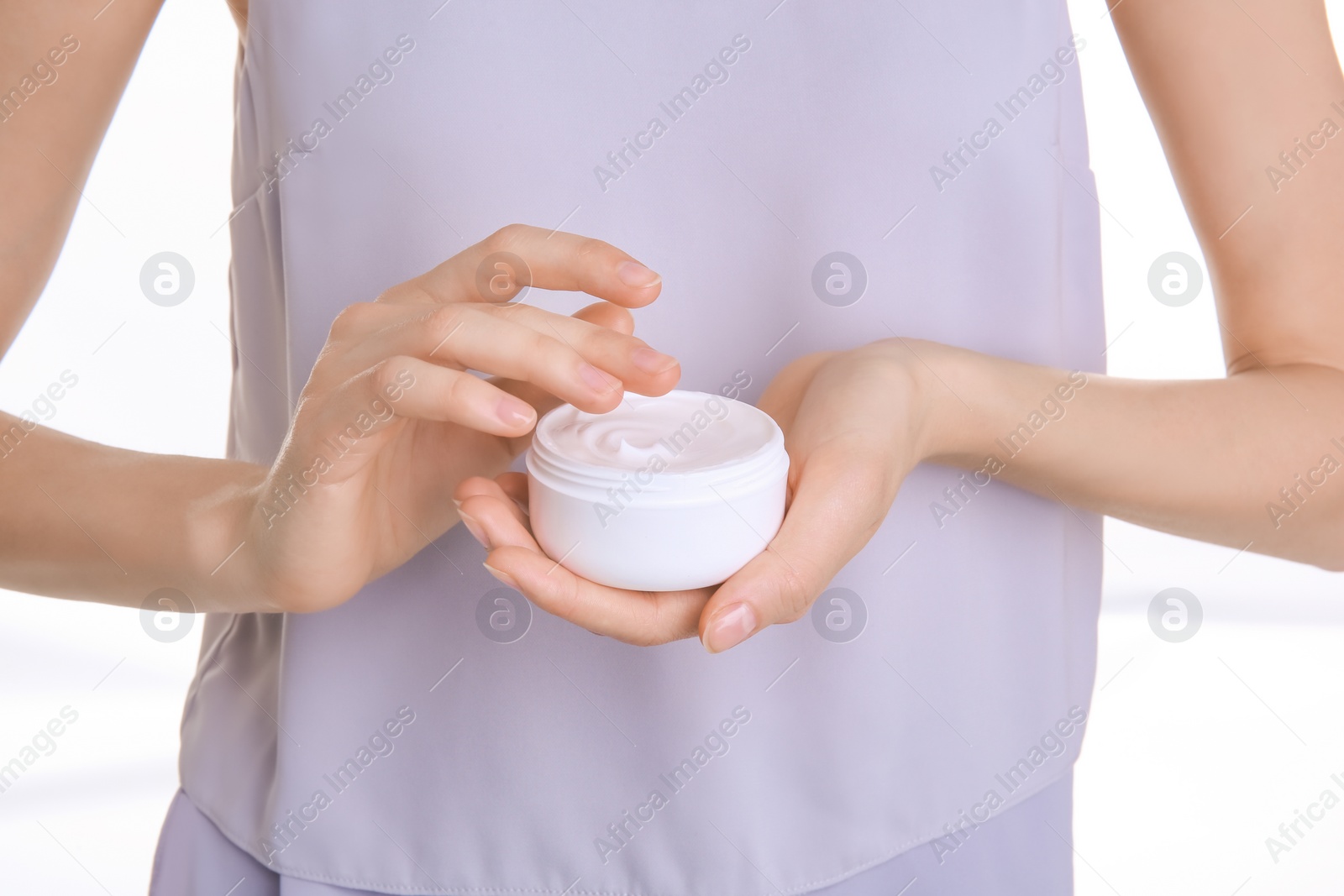 Photo of Young woman holding jar with hand cream, closeup