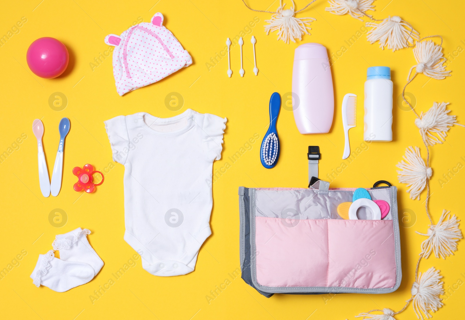 Photo of Flat lay composition with baby accessories and maternity bag on color background