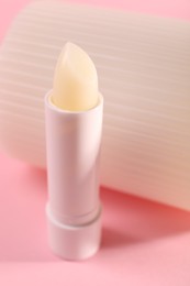 Photo of One lip balm on pink background, closeup