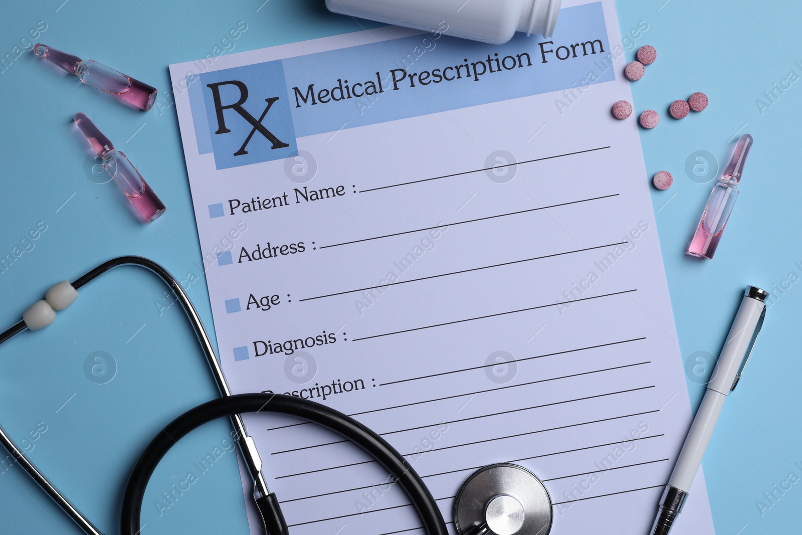 Photo of Medical prescription form, stethoscope, ampoules and pills on light blue background