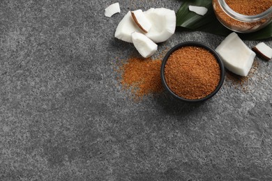 Flat lay composition with natural coconut sugar on grey table, space for text